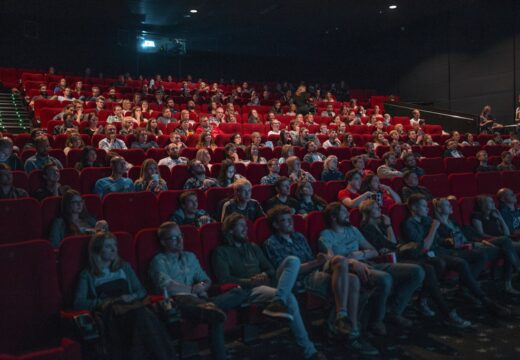 Audience seated in a theater for a live music and entertainment event